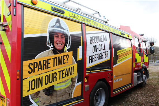 Fire engine with livery showing on-call firefighter recruitment opportunities.
